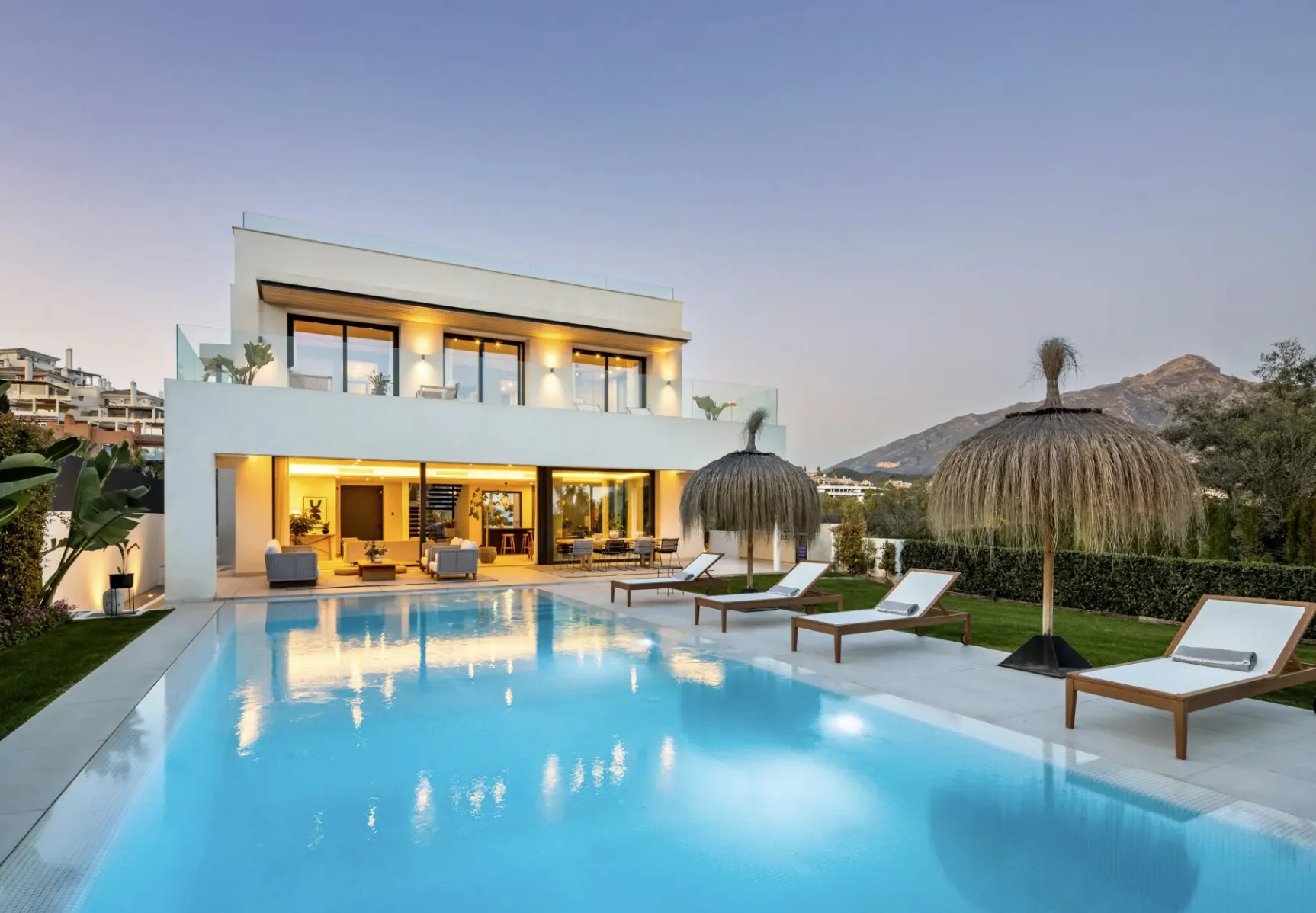 Marbella Golden Mile beachfront developments at twilight showing contemporary luxury properties with La Concha mountain backdrop