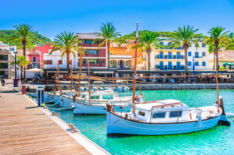 Aerial view of Port d'Andratx marina and luxury waterfront villas at golden hour, Majorca luxury property