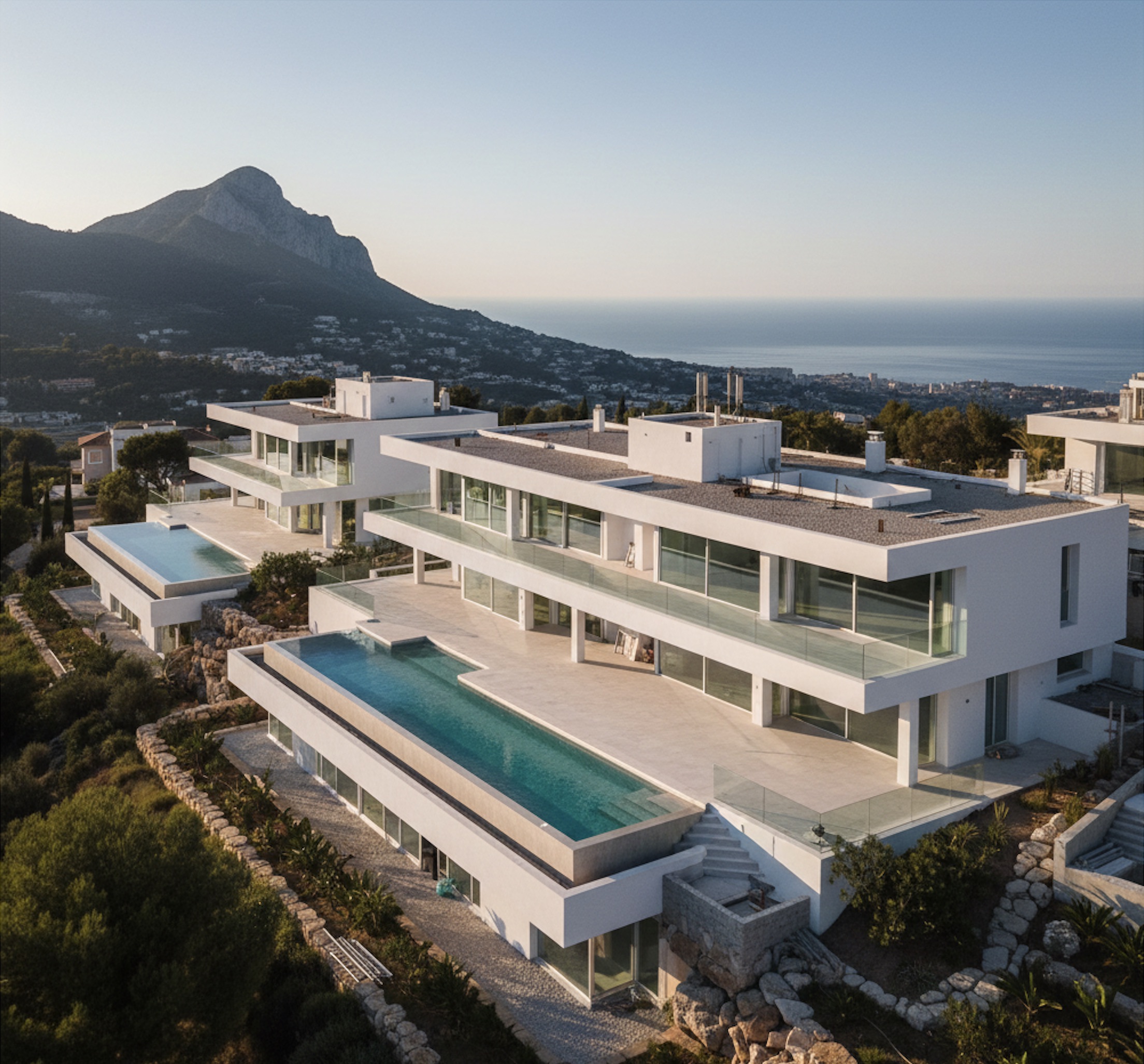 Contemporary luxury development under construction on Marbella hillside showing premium residential architecture with Mediterranean sea views