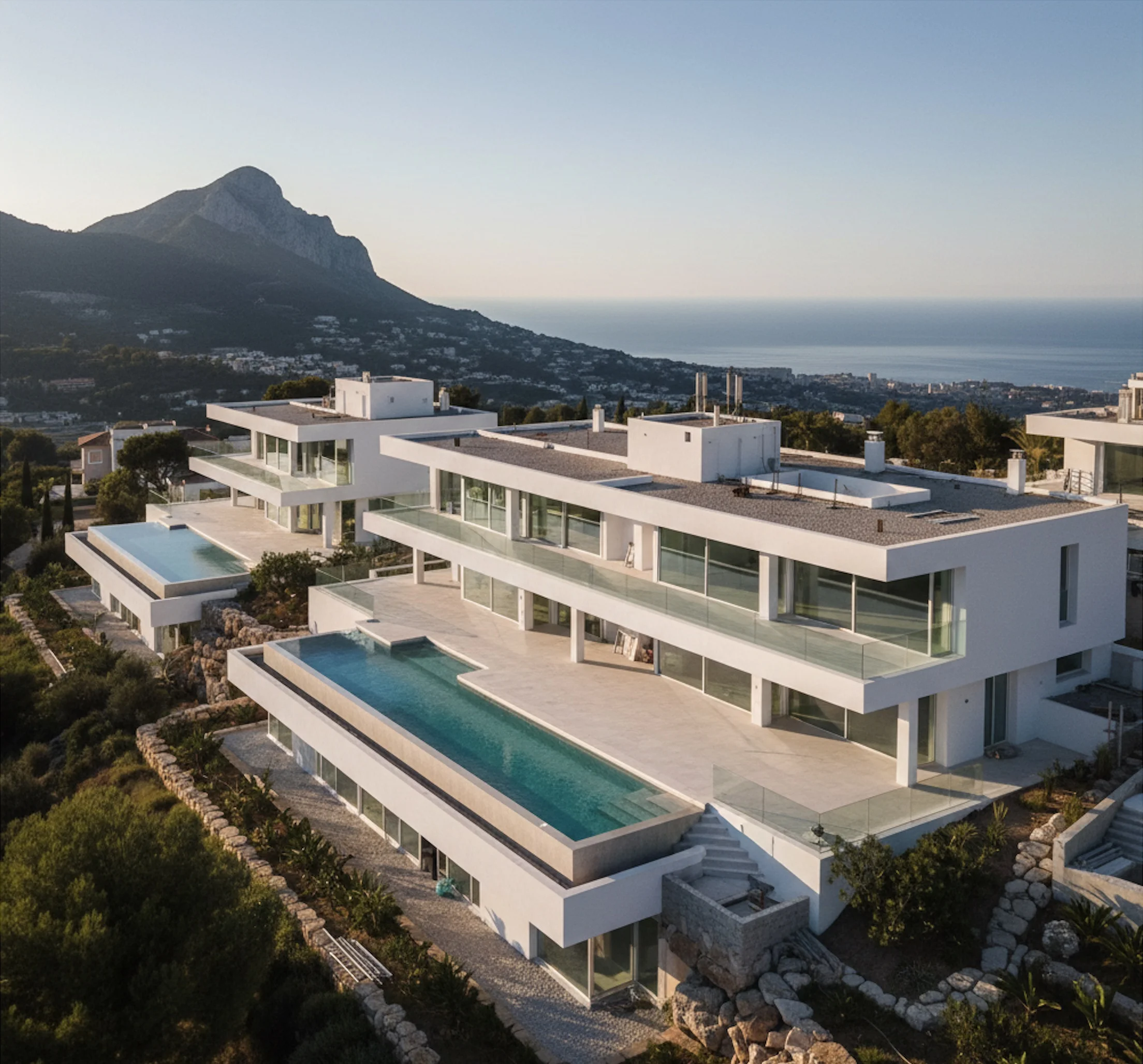 Contemporary luxury development under construction on Marbella hillside showing premium residential architecture with Mediterranean sea views