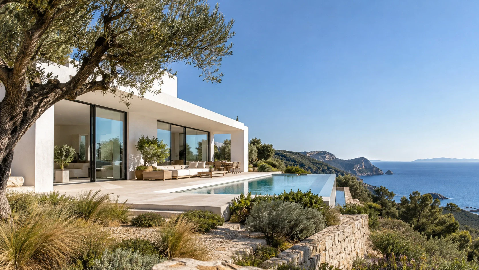 A contemporary white villa with a minimalist garden on an Ibiza hillside.